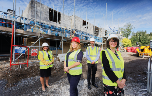 Jan Quarrington with the Caredig team outside one of their housing developments